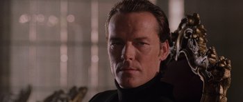 Movie still from “Lara Croft: Tomb Raider” (2001), directed by Simon West – A person wearing a black shirt; Close Up shot, Low angle