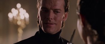 Movie still from “Lara Croft: Tomb Raider” (2001), directed by Simon West – A person wearing a black shirt; Close Up shot, Low angle