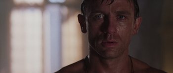 Movie still from “Lara Croft: Tomb Raider” (2001), directed by Simon West – A man's face in a dark room; Close Up shot, Low angle