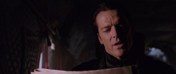 Movie still from “Lara Croft: Tomb Raider” (2001), directed by Simon West – A person looking down at something; Close Up shot, Low angle