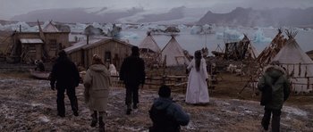 Movie still from “Lara Croft: Tomb Raider” (2001), directed by Simon West – A group of people standing in front of tents and ice bergs; Wide shot, High angle