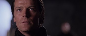 Movie still from “Lara Croft: Tomb Raider” (2001), directed by Simon West – A man's face in the dark; Close Up shot, Low angle