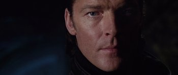 Movie still from “Lara Croft: Tomb Raider” (2001), directed by Simon West – A man's face in the dark; Close Up shot, Low angle