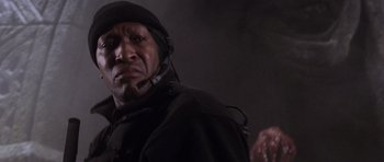 Movie still from “Lara Croft: Tomb Raider” (2001), directed by Simon West – A person wearing a jacket and a hat; Close Up shot, Low angle