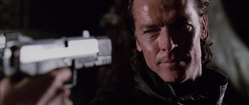 Movie still from “Lara Croft: Tomb Raider” (2001), directed by Simon West – A person with a gun; Close Up shot, Low angle