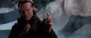 Movie still from “Lara Croft: Tomb Raider” (2001), directed by Simon West – A person holding something in his hand; Close Up shot, Low angle