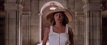 Movie still from “Lara Croft: Tomb Raider” (2001), directed by Simon West – A woman wearing a straw hat in front of an archway; Close Up shot, Low angle