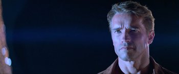 Movie still from “Last Action Hero” (1993), directed by John McTiernan – A person wearing a brown shirt; Close Up shot, Low angle