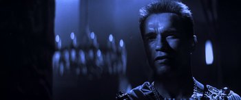 Movie still from “Last Action Hero” (1993), directed by John McTiernan – A person wearing a chain; Close Up shot, Over the shoulder angle