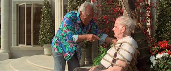 Movie still from “Last Action Hero” (1993), directed by John McTiernan – An older man and an older man sitting on a porch; Medium shot, High angle