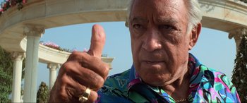 Movie still from “Last Action Hero” (1993), directed by John McTiernan – An older man giving a thumbs up sign; Close Up shot, Low angle