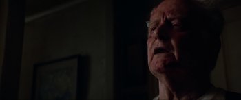 Movie still from “Last Action Hero” (1993), directed by John McTiernan – An old man with a strange look on his face; Close Up shot, Low angle
