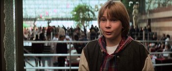 Movie still from “Last Action Hero” (1993), directed by John McTiernan – A young woman standing in front of a group of people; Close Up shot, Low angle