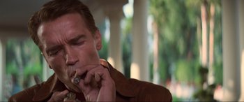 Movie still from “Last Action Hero” (1993), directed by John McTiernan – A person smoking a cigarette; Close Up shot, Low angle