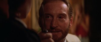 Movie still from “Last Action Hero” (1993), directed by John McTiernan – A person holding a pair of scissors; Close Up shot, Over the shoulder angle