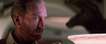 Movie still from “Last Action Hero” (1993), directed by John McTiernan – A man's face as he stares into the distance; Close Up shot, Low angle