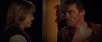 Movie still from “Last Action Hero” (1993), directed by John McTiernan – A man and a woman talking in front of each other; Close Up shot, Over the shoulder angle