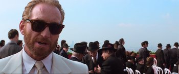 Movie still from “Last Action Hero” (1993), directed by John McTiernan – A crowd of people wearing hats and sunglasses; Close Up shot, Over the shoulder angle