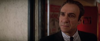 Movie still from “Last Action Hero” (1993), directed by John McTiernan – A person wearing a suit and tie; Close Up shot, Low angle