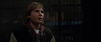 Movie still from “Last Action Hero” (1993), directed by John McTiernan – A young man is looking up at the ceiling; Close Up shot, Over the shoulder angle