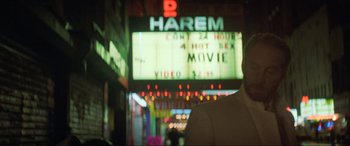 Movie still from “Last Action Hero” (1993), directed by John McTiernan – A man standing in front of a movie screen; Close Up shot, Over the shoulder angle