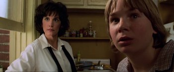 Movie still from “Last Action Hero” (1993), directed by John McTiernan – A woman standing next to a child in a kitchen; Close Up shot, Low angle
