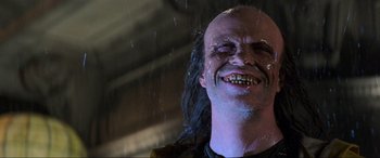 Movie still from “Last Action Hero” (1993), directed by John McTiernan – A person wearing a mask; Close Up shot, Low angle