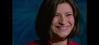 Movie still from “Laura Pausini: Pleasure to Meet You” (2022), directed by Ivan Cotroneo – A person smiling for the camera; Close Up shot, High angle
