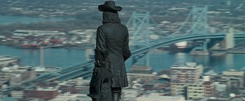 Movie still from “Law Abiding Citizen” (2009), directed by F. Gary Gray – A statue of a man standing on top of a building; Wide shot, High angle