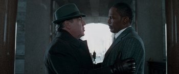 Movie still from “Law Abiding Citizen” (2009), directed by F. Gary Gray – Two men in suits and hats talking to each other; Close Up shot, Over the shoulder angle