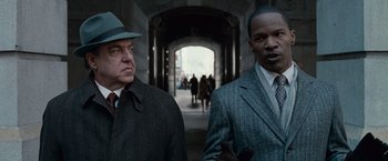Movie still from “Law Abiding Citizen” (2009), directed by F. Gary Gray – Two men in suits and hats standing next to each other in an archway; Close Up shot, Over the shoulder angle