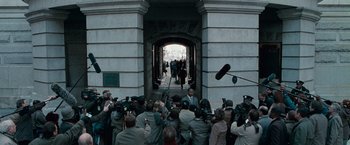 Movie still from “Law Abiding Citizen” (2009), directed by F. Gary Gray – A group of people standing in front of an archway; Extreme Wide shot, Over the shoulder angle