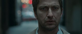 Movie still from “Law Abiding Citizen” (2009), directed by F. Gary Gray – A man's face in the dark; Close Up shot, Over the shoulder angle