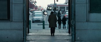 Movie still from “Law Abiding Citizen” (2009), directed by F. Gary Gray – A man is walking down the sidewalk of a busy street; Wide shot, Over the shoulder angle