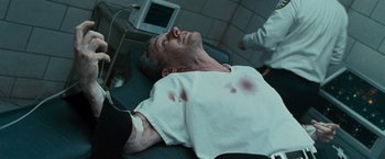 Movie still from “Law Abiding Citizen” (2009), directed by F. Gary Gray – A man laying on a hospital bed with blood on his face; Close Up shot, High angle