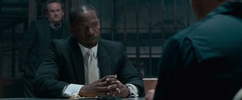 Movie still from “Law Abiding Citizen” (2009), directed by F. Gary Gray – A man sitting at a table in front of a woman; Close Up shot, Over the shoulder angle