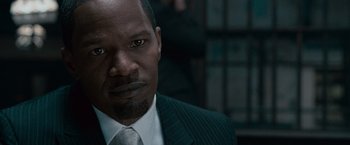 Movie still from “Law Abiding Citizen” (2009), directed by F. Gary Gray – A person wearing a suit and tie; Close Up shot, Over the shoulder angle