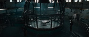Movie still from “Law Abiding Citizen” (2009), directed by F. Gary Gray – A person in a cage in a dark room; Extreme Wide shot, High angle