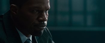 Movie still from “Law Abiding Citizen” (2009), directed by F. Gary Gray – A person wearing a suit and tie; Close Up shot, Over the shoulder angle