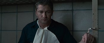 Movie still from “Law Abiding Citizen” (2009), directed by F. Gary Gray – A person holding a towel; Close Up shot, Over the shoulder angle