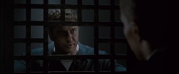 Movie still from “Law Abiding Citizen” (2009), directed by F. Gary Gray – A man looking through bars of a jail cell; Close Up shot, Over the shoulder angle