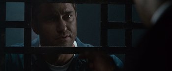 Movie still from “Law Abiding Citizen” (2009), directed by F. Gary Gray – A person behind a fence; Close Up shot, Over the shoulder angle