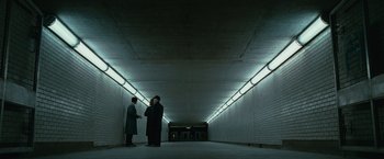 Movie still from “Law Abiding Citizen” (2009), directed by F. Gary Gray – Two men standing in an underground tunnel with lights; Extreme Wide shot, High angle