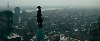 Movie still from “Law Abiding Citizen” (2009), directed by F. Gary Gray – A statue on top of a building overlooking a large city; Extreme Wide shot, High angle