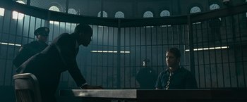 Movie still from “Law Abiding Citizen” (2009), directed by F. Gary Gray – Two men are in a jail cell talking to one another; Wide shot, Over the shoulder angle