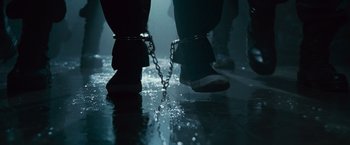 Movie still from “Law Abiding Citizen” (2009), directed by F. Gary Gray – A pair of feet chained to each other on a wet floor; Extreme Close Up shot, Low angle