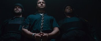Movie still from “Law Abiding Citizen” (2009), directed by F. Gary Gray – Two men are chained to a wall in a dark room; Medium shot, Low angle