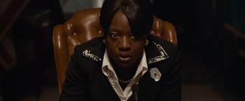 Movie still from “Law Abiding Citizen” (2009), directed by F. Gary Gray – A person sitting in a chair wearing a jacket; Close Up shot, Over the shoulder angle