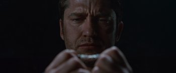 Movie still from “Law Abiding Citizen” (2009), directed by F. Gary Gray – A person holding something in their hands; Extreme Close Up shot, High angle