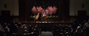 Movie still from “Law Abiding Citizen” (2009), directed by F. Gary Gray – A person playing a musical instrument on a stage; Extreme Wide shot, High angle